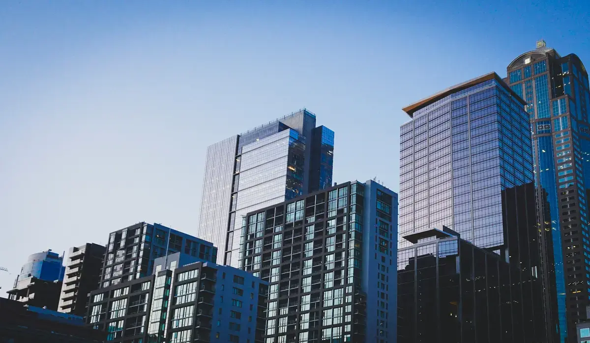 white and blue glass-walled high-rise building